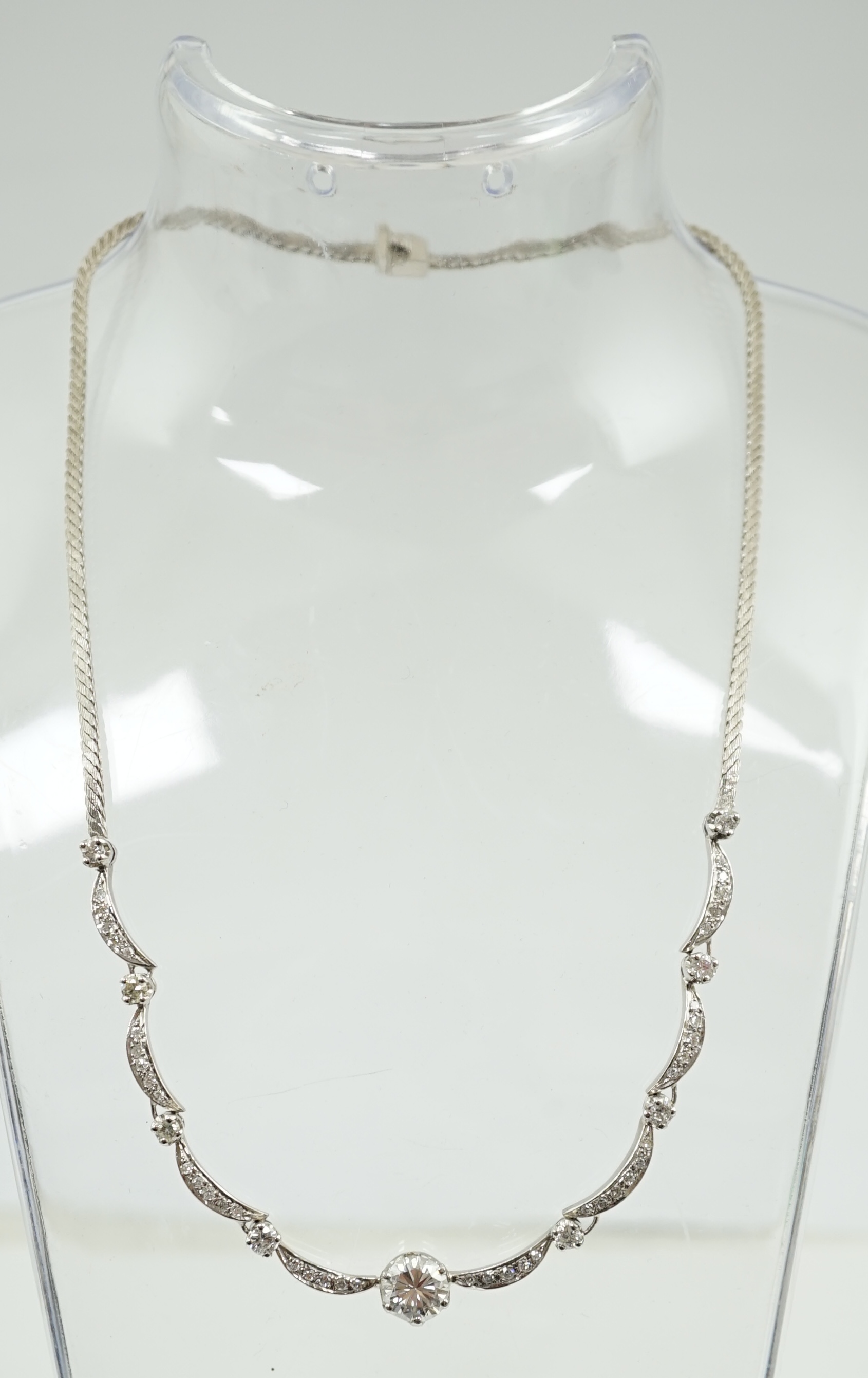 A modern 18ct white gold and diamond cluster set necklace